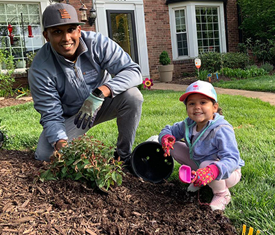 Teaching his daughter how to garden