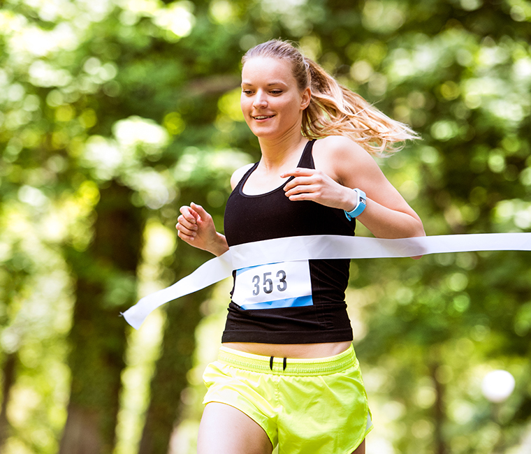 young girl crossing finish line