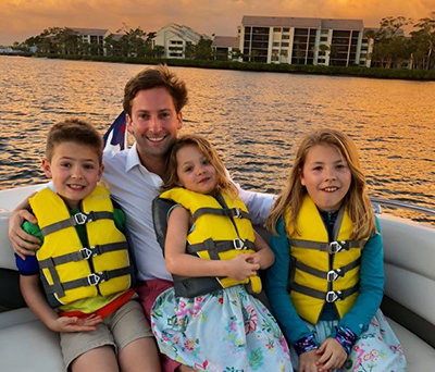 Dr. Wick in a boat with his nieces and nephew